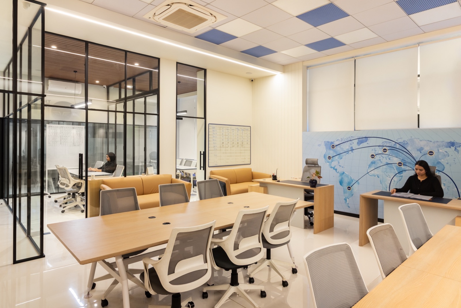 ThePilot.in student-counselling and admin area with a world aviation map wall