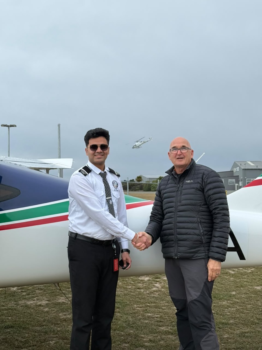 ThePilot.in cadet shaking hands with an instructor beside a P2008 trainer after a successful sortie