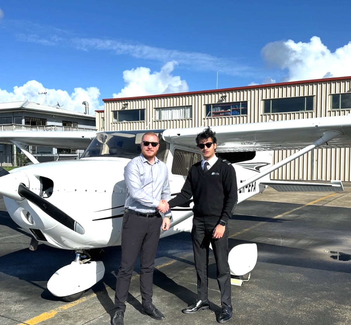 ThePilot.in student pilot shaking hands with an instructor after completing a check ride